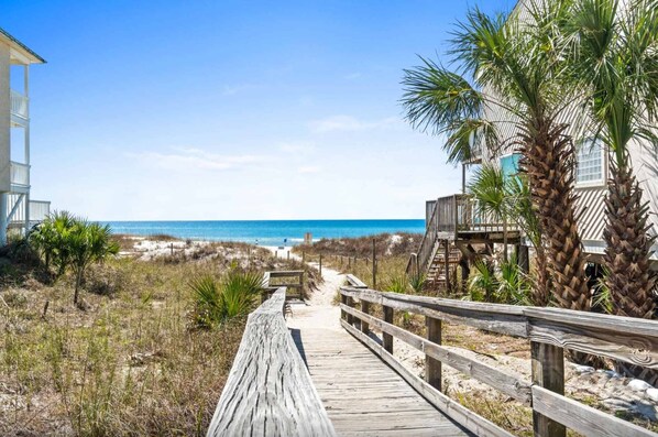 A wooden boardwalk leading to a beach with a clear view of the ocean. - Renovated Townhome with Central AC, Shared Pools & Hot Tubs–Minutes to Beach (Panama City Beach)