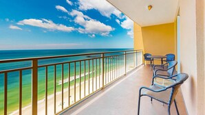 A balcony with a view of the beach and ocean. - Waterfront condo with grills, pool & fitness center - walk to the beach (Panama City Beach)