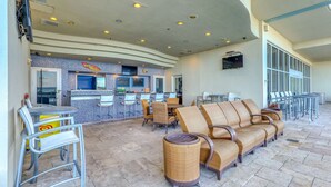 A spacious indoor seating area with a bar and lounge chairs. - 7th-floor resort studio with partial Gulf views, outdoor pool, gym & hot tub (Panama City Beach)
