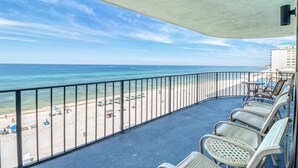 A balcony with a view of a beach and ocean. - Centrally located condo w/ private balcony, Pool & Hot tub (Panama City Beach)