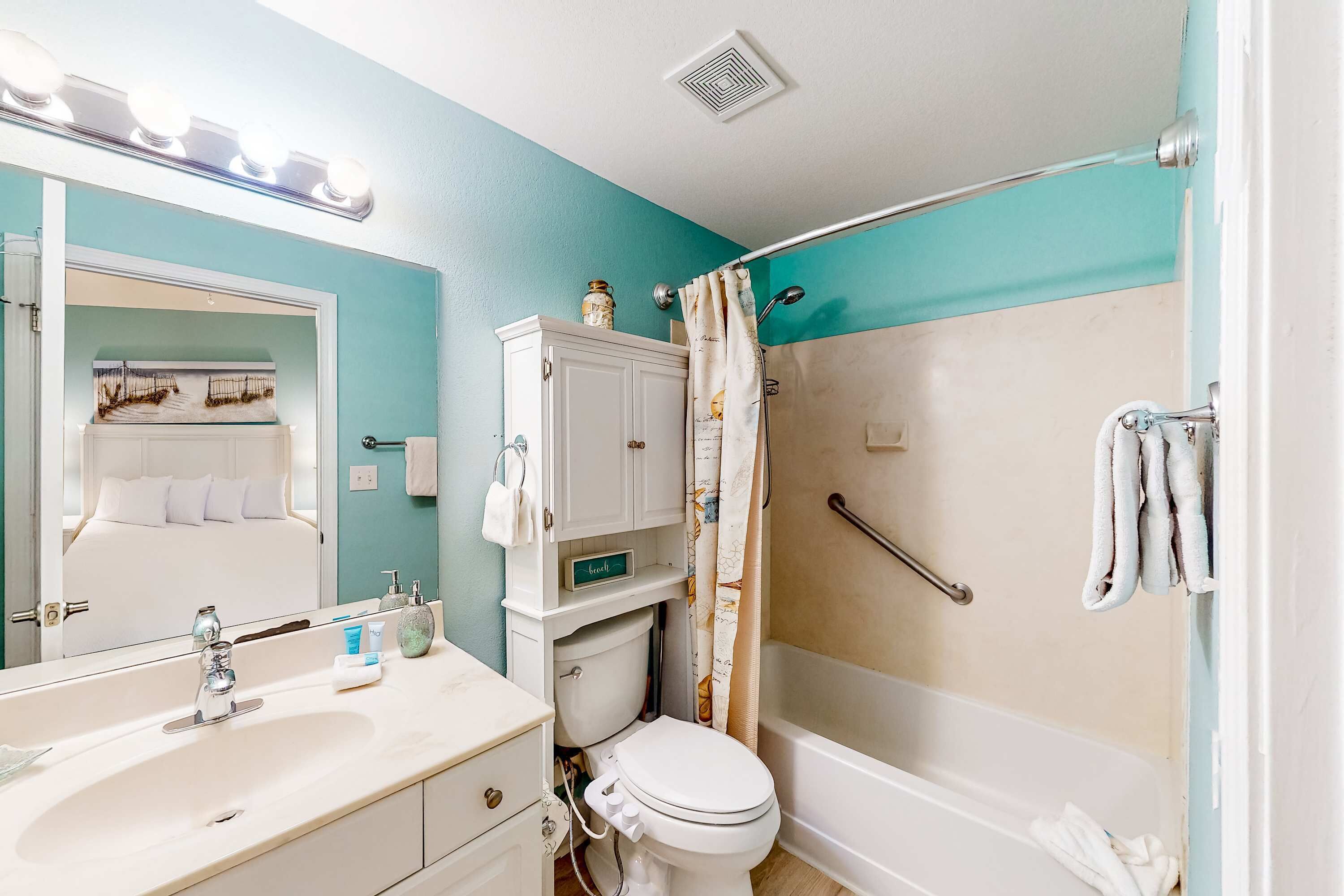A bathroom with a sink, toilet, and bathtub.