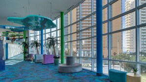 Un hall d’entrée spacieux, doté de grandes fenêtres, d’un sol à motifs et d’espaces de détente modernes.