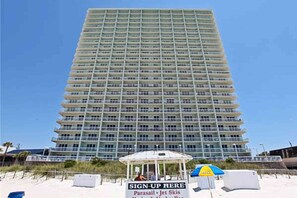A tall, multi-story hotel with a uniform facade and balconies. - Serene & upscale beachfront condo with furnished balcony, view, & pools (Panama City Beach)
