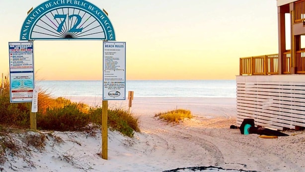 A beach entrance sign with beach rules and a lifeguard warning. - Condo in Panama City Beach with pool & beach access (Panama City Beach)