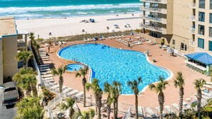 A resort with a large swimming pool, beach access, and high-rise buildings. - Lovely condo at beachfront resort with sunset views, pools, hot tubs, & gym (Panama City Beach)