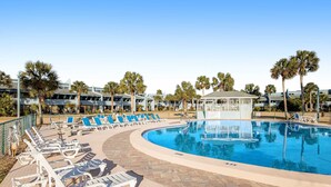 A pool area with lounge chairs and a gazebo. - Convenient condo with WiFi, W/D, shared pool, tennis, & bocce, and more (Panama City Beach)