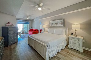 A bedroom with a bed, dresser, nightstands, and a ceiling fan. - Beautifully decorated oceanfront condo with resort pool, & huge walk-in showers (Santa Rosa Beach)