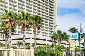 A high-rise building with a sign for 'Funbird Condominiums' and a gated entrance. - Snowbird-friendly condo in Panama City Beach with shared pool (Panama City Beach)