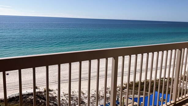 A balcony with a view of the ocean and beach. - Cozy beachfront condo with private balcony, shared pool & beach access (Panama City Beach)