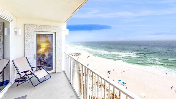 A balcony with a view of a beach and ocean. - Gulf-front getaway with pools, hot tub & central AC (Panama City Beach)