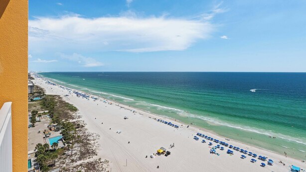 A beach with a clear sky, a sandy shore, and a view of the ocean. - Beachfront resort condo with Gulf views, outdoor pool, & private balcony (Panama City Beach)