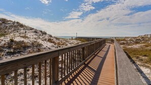 A wooden boardwalk leading to a beach with a clear sky. - First-floor condo with sauna, gym, pool, tennis & pickleball (Santa Rosa Beach)