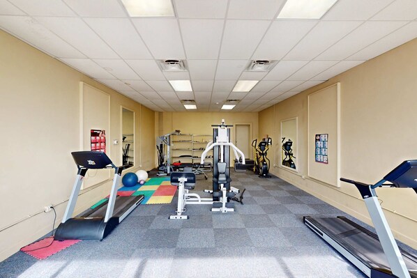 A gym with treadmills, weight machines, and exercise balls. - Gulf-view condo with furnished balcony, pools, beach access, fitness room (Panama City Beach)