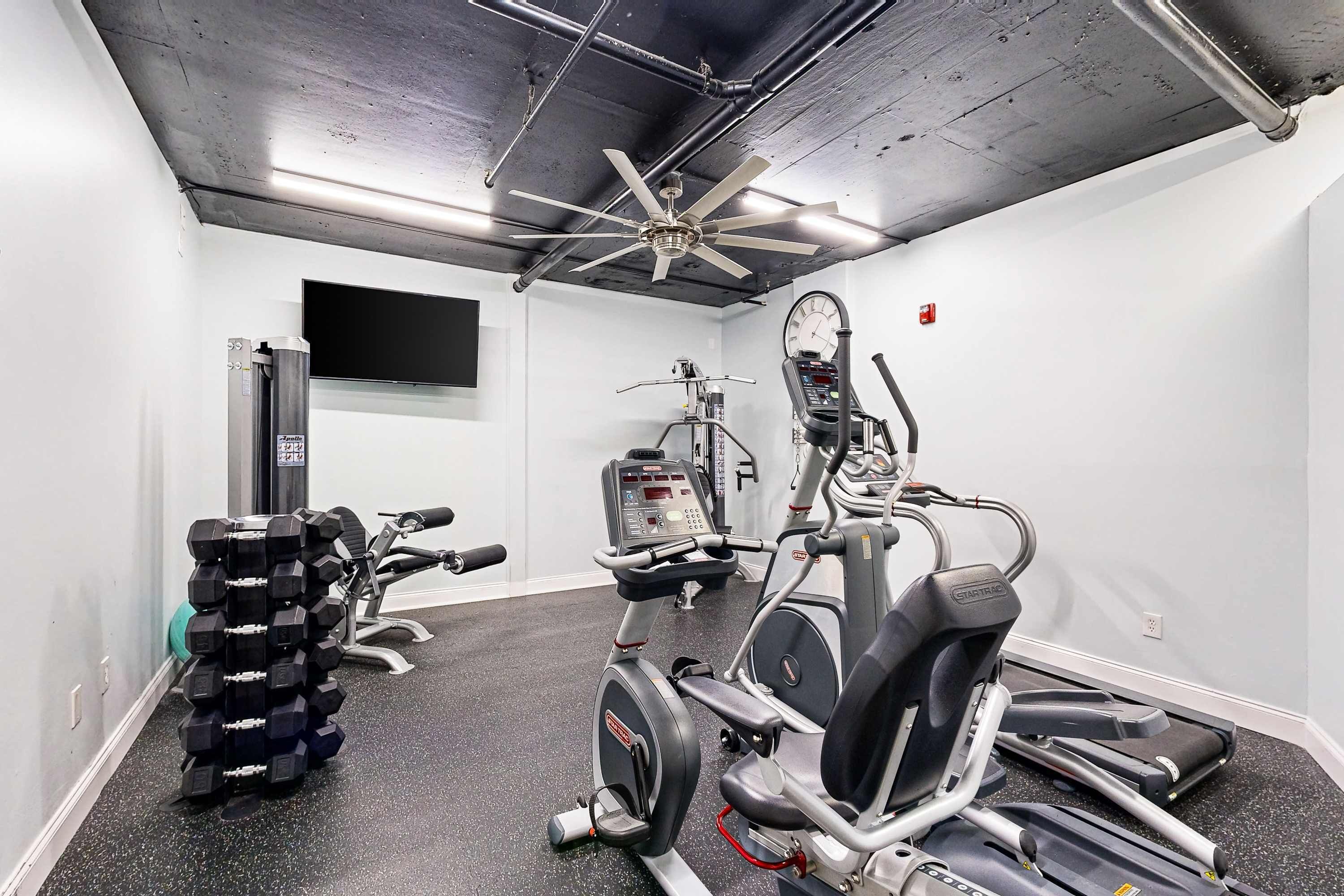 A gym with treadmills, an elliptical, and a weight stack.