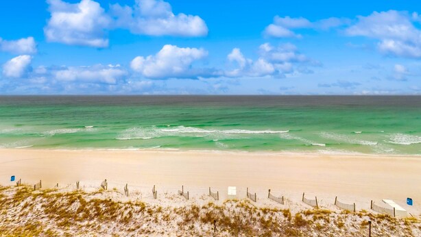 A beach with a clear sky and ocean. - Cozy beachfront condo with beach setup - near shopping (Fort Walton Beach)