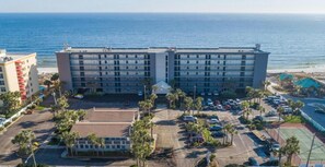 A multi-story hotel with a parking lot and a view of the ocean. - Updated beachfront condo with beach setup & quick drive to entertainment (Fort Walton Beach)
