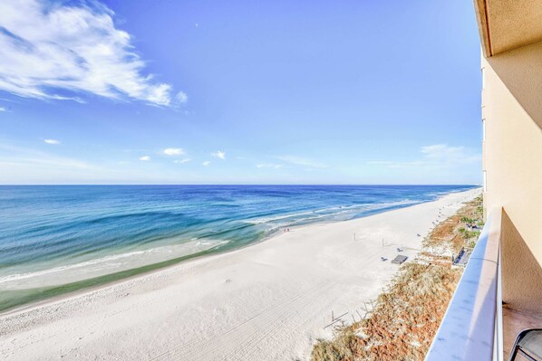 A beach view from a balcony with a clear sky and ocean. - Welcoming, beachfront condo with Gulf views, pools & fitness center (Panama City Beach)