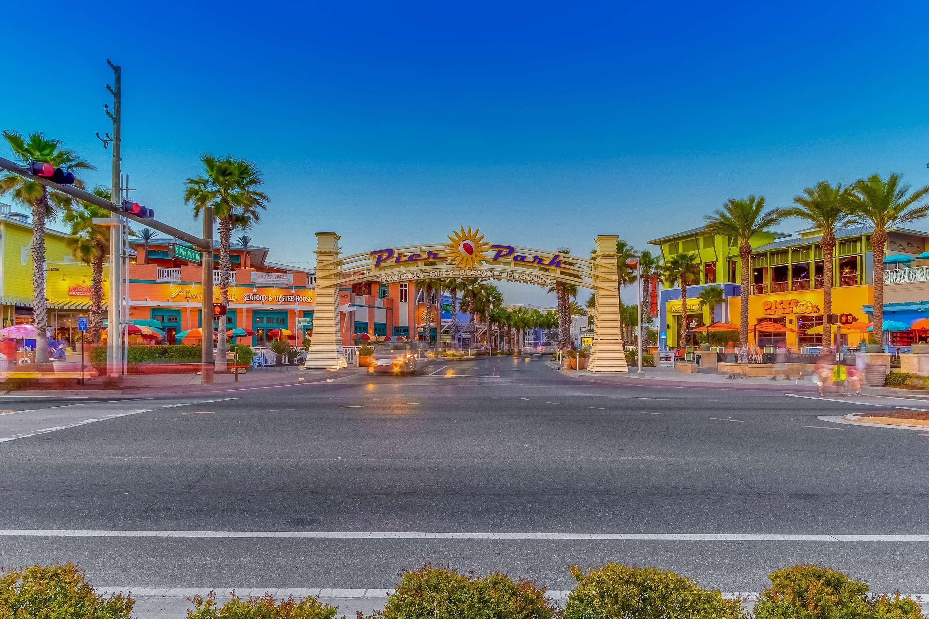 A street view with a prominent archway labeled "Pier Park" and various storefronts.