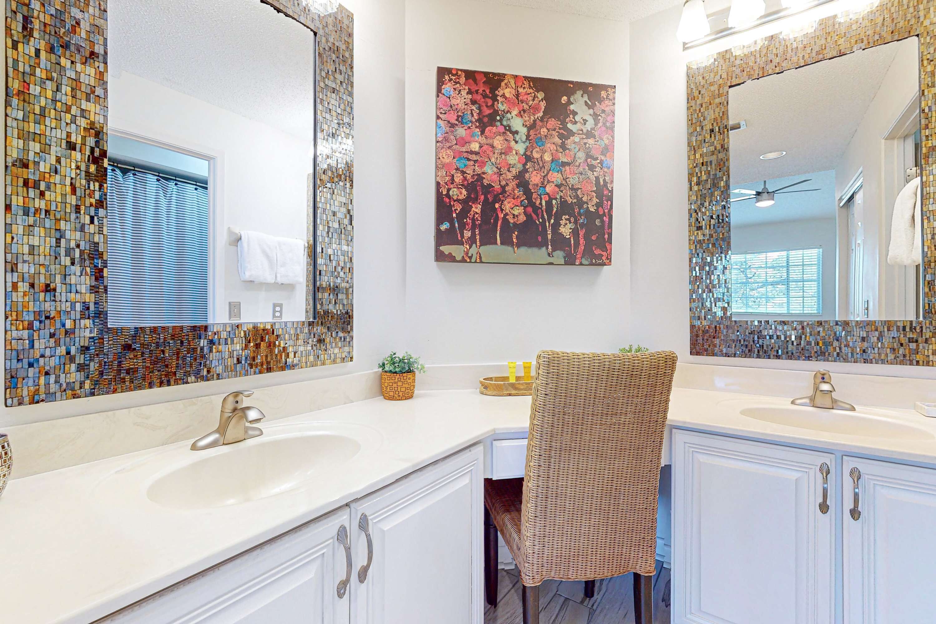 A bathroom with two sinks, a large mirror, and a mosaic tile backsplash.
