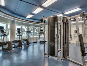 A gym with various exercise equipment, large windows, and a ceiling with exposed ductwork. - Ground-Floor Condo At Waterscape Waterfall, Lazy River, Beach Chairs (Fort Walton Beach)