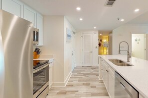 A modern kitchen with stainless steel appliances, a wooden countertop, and a built-in oven. - 4th-floor remodeled condo with pool, hot tub, fitness room, balcony & lazy river (Fort Walton Beach)