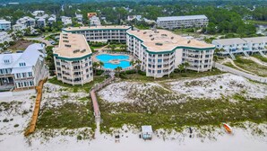 A hotel with a pool, multiple buildings, and a beach area. - Beach-view condo with outdoor pool, hot tub, sauna, tennis, BBQ, & beach access (Santa Rosa Beach)