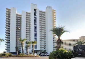 A high-rise hotel with multiple floors, a prominent entrance, and a sign indicating the name 'Palacio'. - 6th-floor charming condo with amazing views & pools (Perdido Key)