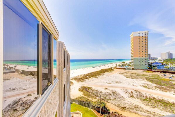 A high-rise hotel with a view of a beach and ocean. - Beachfront Condo with Access to Pool, Gym, & Game Room - Snowbirds Welcome (Panama City Beach)