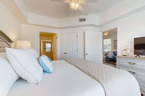 A bedroom with a large bed, a ceiling fan, and a dresser. - 2BR Blue Mountain Beach Condo | Shared Pool | Gym | 2 Bikes (Santa Rosa Beach)