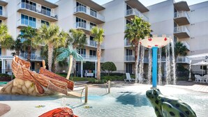 A water park area with a large frog statue, a water slide, and a pool. - Inviting, Spacious Condo On Okaloosa Island Playground, 2 Hot Tubs (Fort Walton Beach)