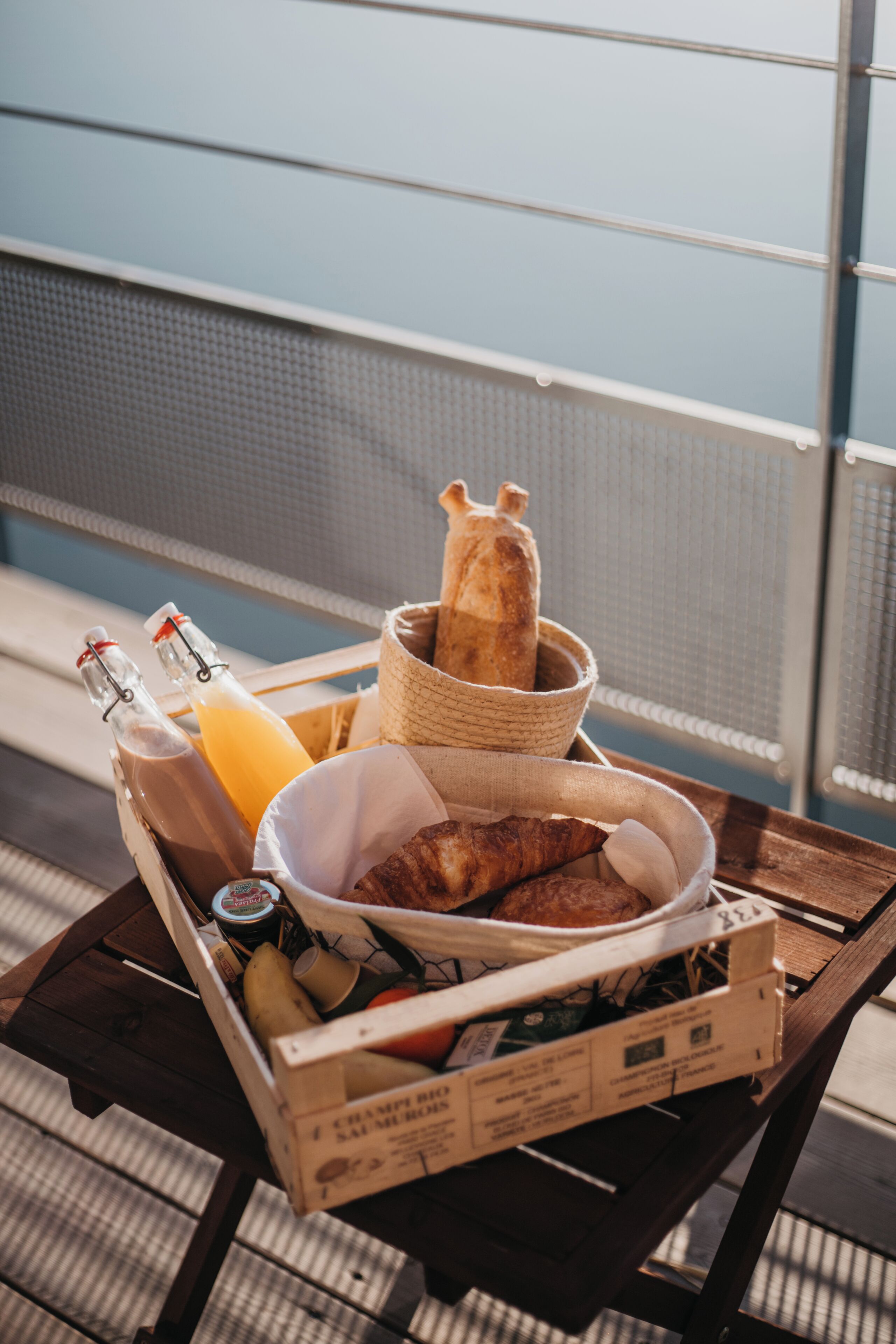 A tray with food items, including bread, a bottle of juice, and a box of bread.