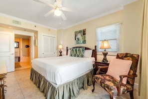 A bedroom with a large bed, a chair, a nightstand, and a ceiling fan. - Spacious Condo At Waterscape Lovely Gulf Views Playground, 2 Hot Tubs (Fort Walton Beach)