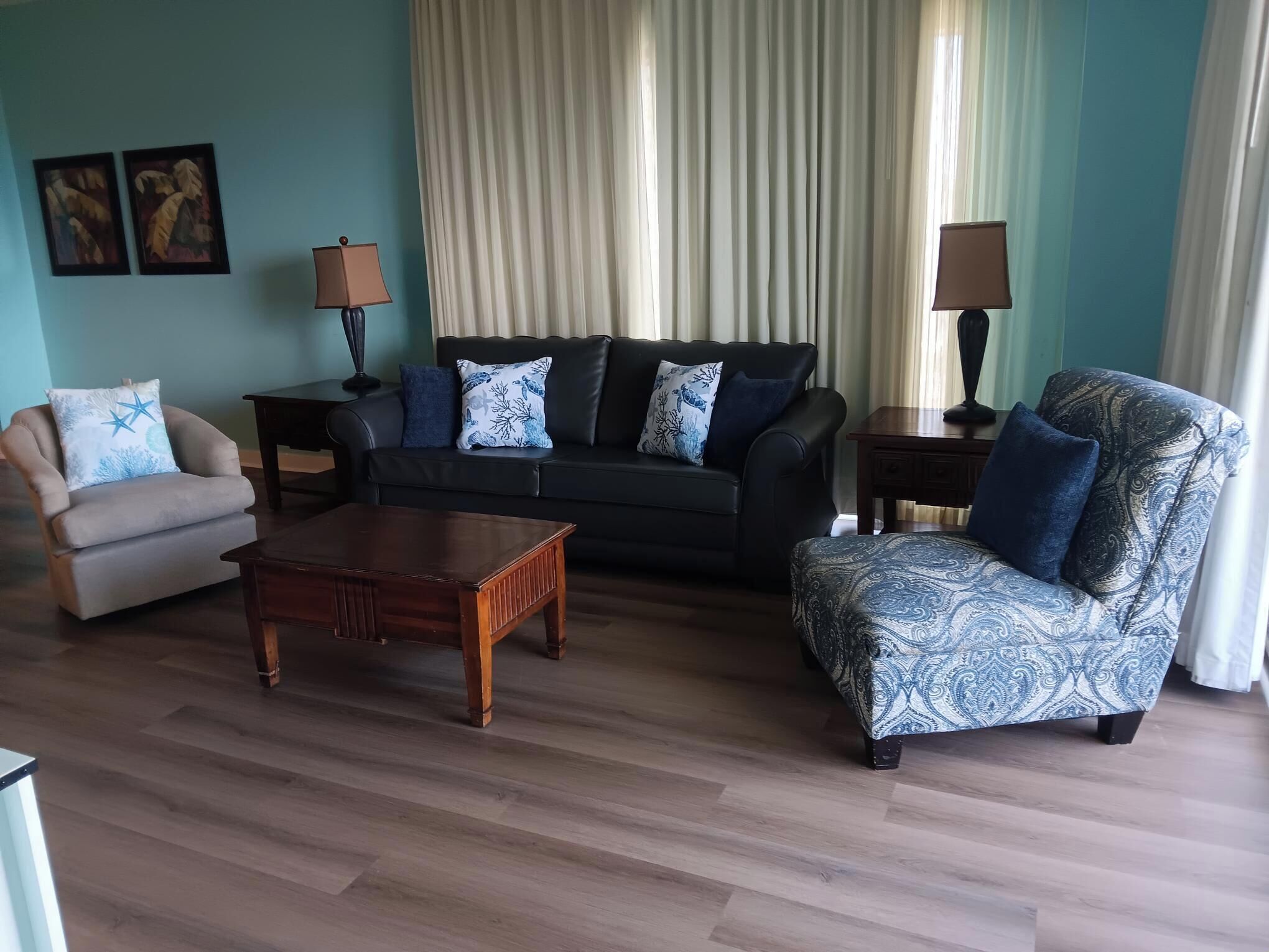 A living room with a sofa, armchair, and coffee table.