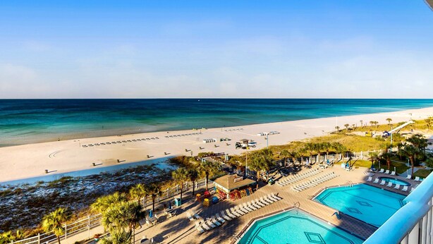 A resort with a beach view, a pool area, and a fenced swimming area. - Gulf-front condo with balcony, W/D, direct beach access, pools, hot tub & gym (Panama City Beach)