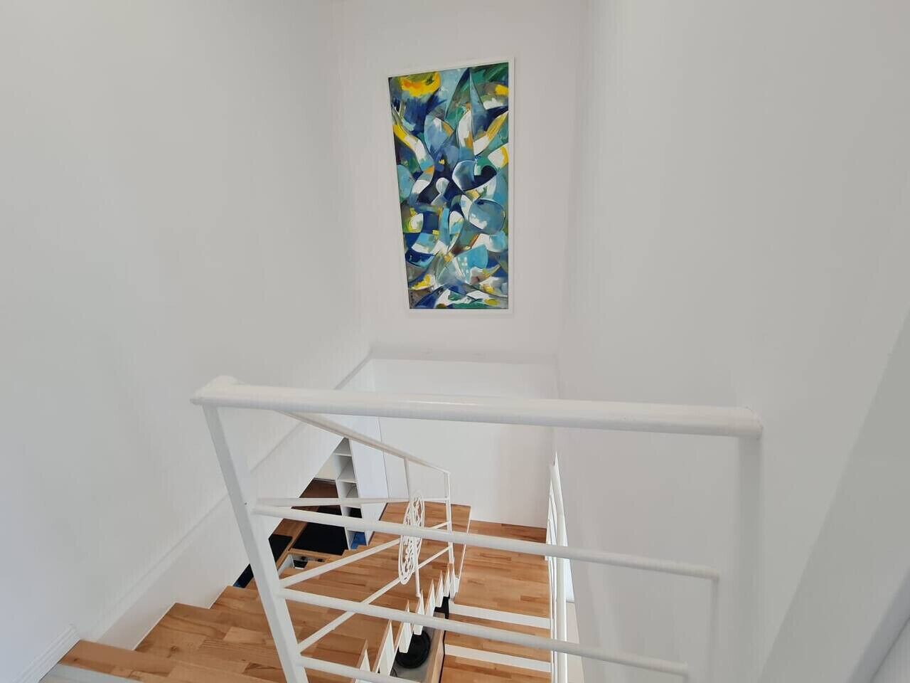A staircase with white railings and wooden steps.