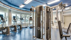 A gym with various exercise machines, including treadmills and weightlifting equipment. - Bright, beachy condo At Waterscape w children's playground, 2 hot tubs (Fort Walton Beach)