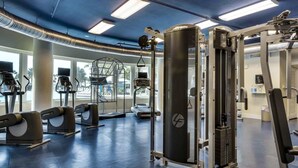 A gym with treadmills, weight machines, and a squat rack. - 3rd Floor Picturesque Condo On Okaloosa Island Waterfall, Lazy River (Fort Walton Beach)