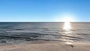 A beach with waves and a clear sky. - Fifth-floor oceanfront condo with high-speed WiFi, Gulf view, Pools & Hot tub (Panama City Beach)