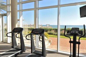 A gym with treadmills and a view of the ocean. - Beautiful, Gulf-front townhome with three water-view decks - near entertainment (Perdido Key)