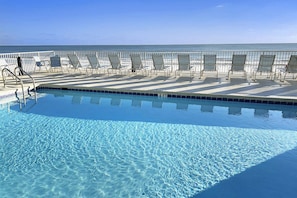 A clear blue pool with sun loungers and a view of the ocean. - Comfortable unit, Breathtaking views, Quick walk to dining (Miramar Beach)