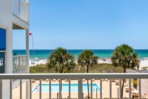 A pool area with a view of the beach and ocean. - 2-story condo with Gulf views, on-site pool, balconies, & easy beach access (Panama City Beach)