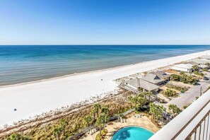 A beachfront hotel with a pool, beach access, and a clear view of the ocean. - Gulf-front Condo w/ Shared Pool & Hot Tub, Ocean Views, WiFi, and Washer/Dryer (Panama City Beach)
