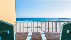 Ein Balkon mit Blick auf Strand und Meer.