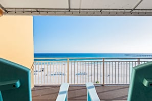 A balcony with a view of the beach and ocean. - Colorful, waterfront condo with beach access, pool & fitness center (Panama City Beach)