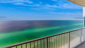 A balcony with a view of the ocean and a clear sky. - Beach-chic gulf-front condo w resort pools, hot tubs & beach service (Panama City Beach)