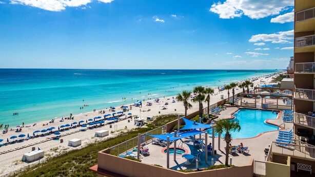 A resort with a pool, beach, and ocean view. - Gorgeous beachfront condo, shared pool and beach access (Panama City Beach)