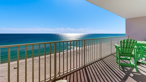 A balcony with a view of the ocean, a white railing, and green chairs. - Inviting Gulf-front condo In Perdido Key with waterfront pool/hot tub and oceanfront balcony (Perdido Key)