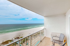 A balcony with a view of a beach and ocean. - Oceanfront condo with beach access, pools & hot tubs (Panama City Beach)