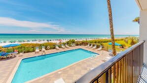 A pool area with a view of the beach and ocean. - Luxury, oceanfront condo with outdoor pool & patio - snowbird-friendly (Miramar Beach)