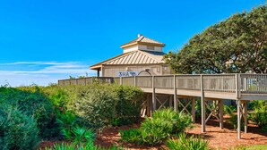 A wooden deck with a sign reading "3A" leading to a building with a metal roof. - Gorgeous home with tennis, pickleball, pool & hot tub - steps from the beach (Seacrest)